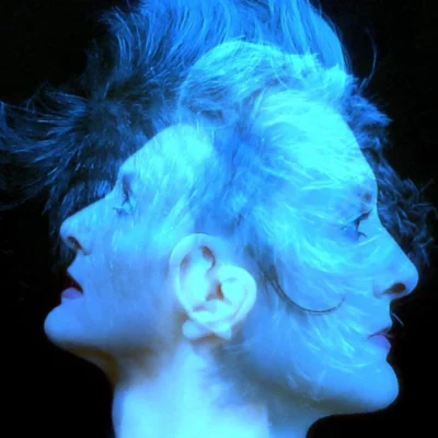La chanteuse et autrice Marilyne Maillot dans une photo du projet Vénus en Mars : son visage doublé, de deux côtés opposé, couleur bleue et sur un fond noir