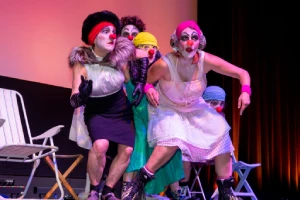 Cinq femmes sur une scène de théâtre déguisées en clown